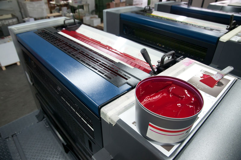 UV Ink being loaded into an offset press