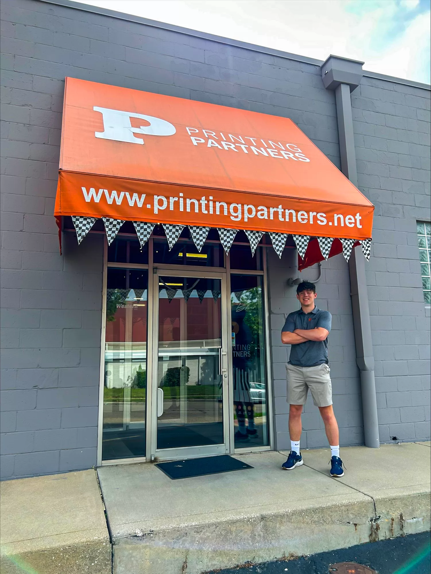 Logan O'Brien in front of Printing Partners