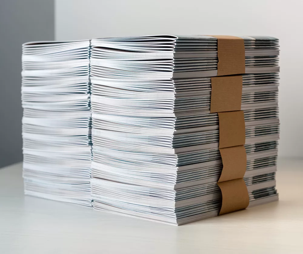 Bundles of newly printed catalogues in a stack