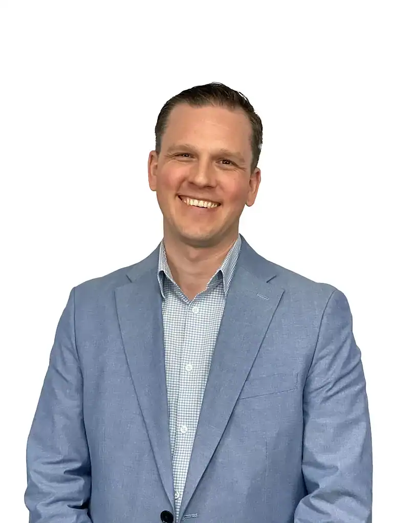 Noah Evans smiling while wearing a light blue suit and a checkered shirt.