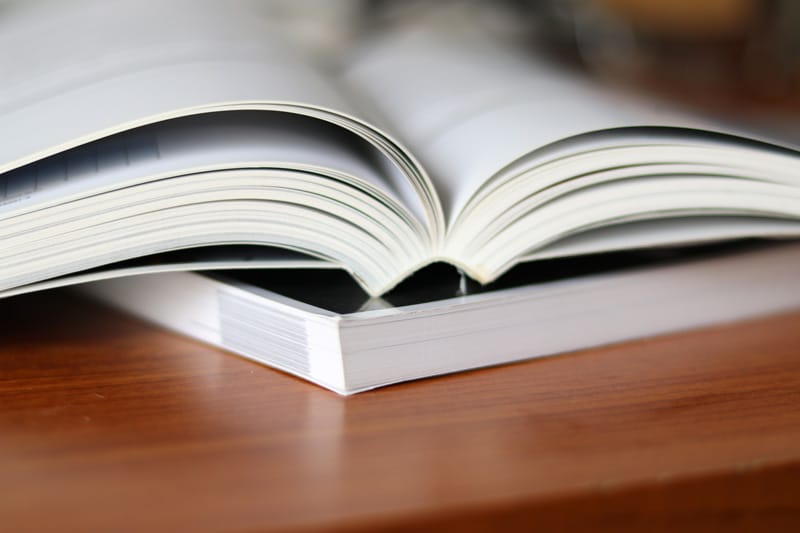 Open perfect bound paperback showing the flat glued spine.