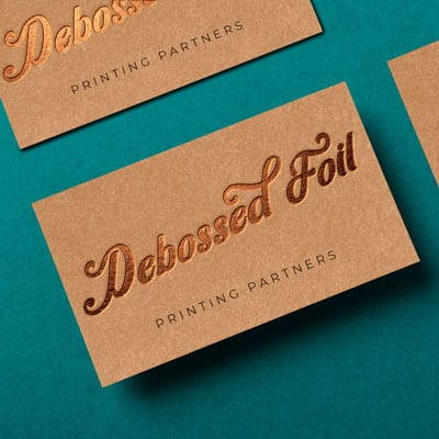 Debossed foil lettering on kraft paper business cards from Printing Partners.