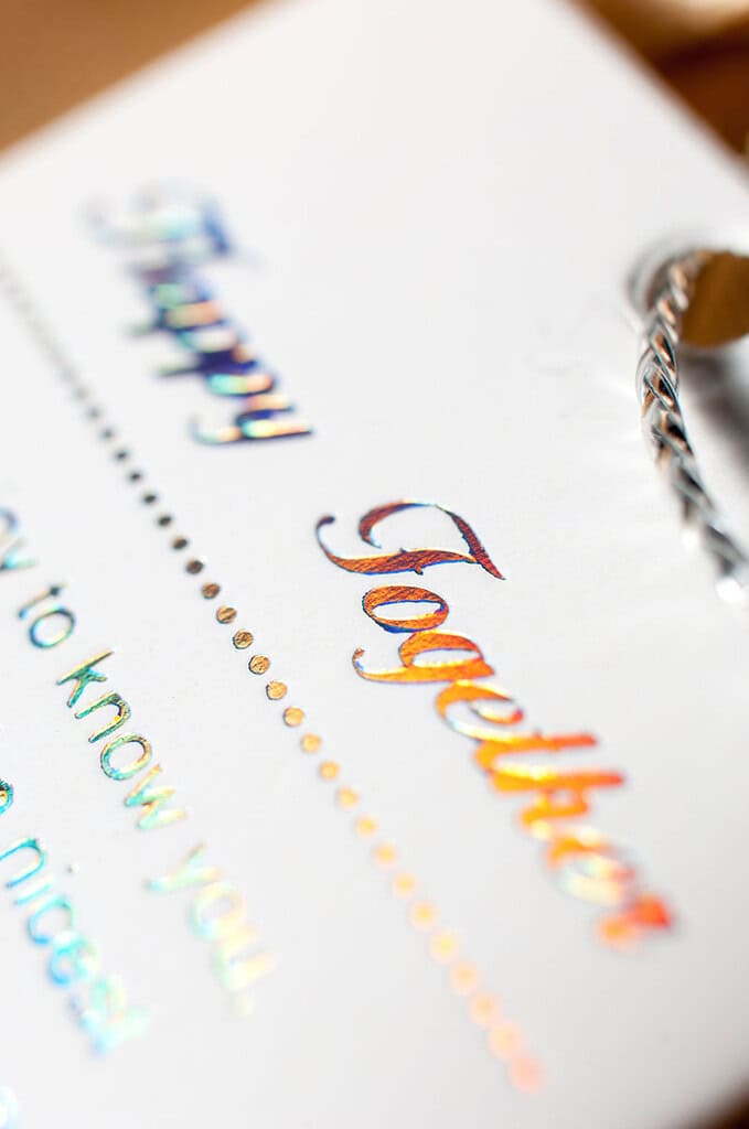 Greeting card with foil stamping that reads 'Happy Together' in colorful letters.