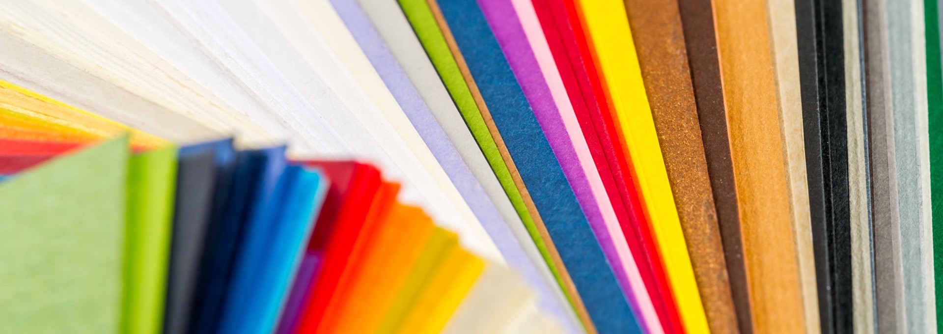 Fanned stack of colored cardstock swatches in many finishes