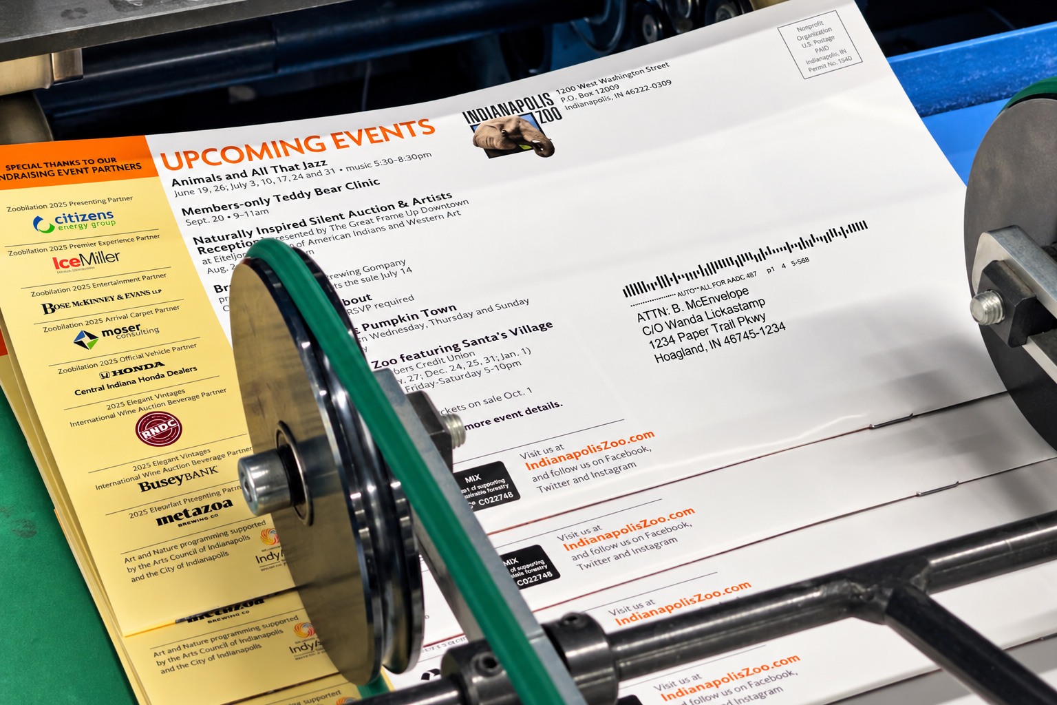 Indianapolis Zoo newsletter mailers passing through mailing equipment